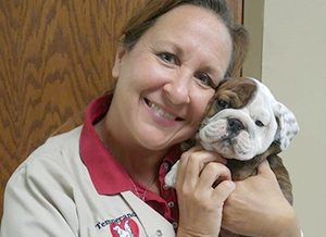 Vet holding a puppy: In-House Pharmacy in Temperance